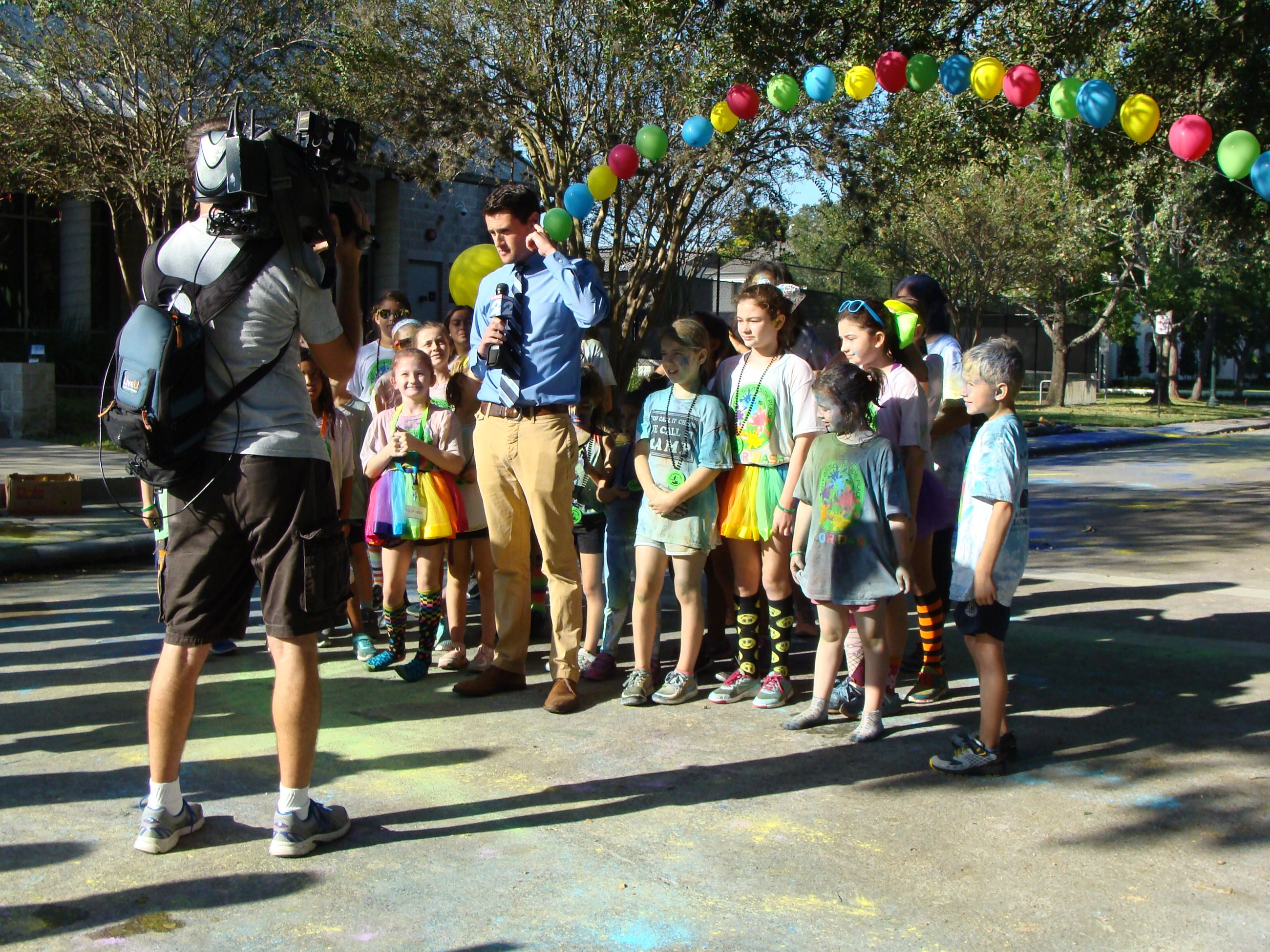 Group of children with a reporter at the finish line